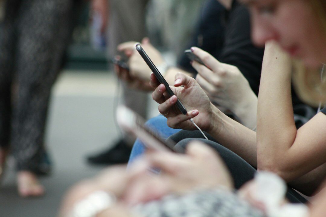 people using smartphones in public